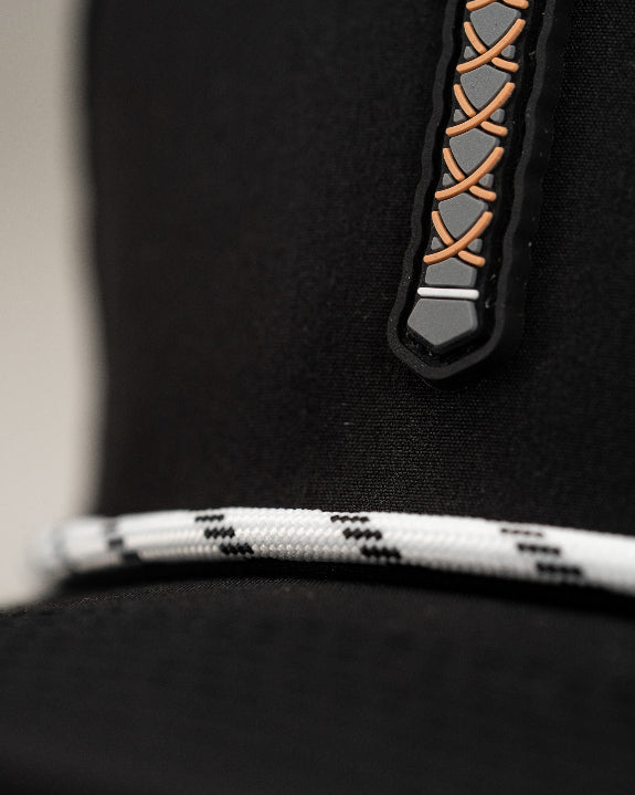 Thor’s Hammer Black perforated rope golf hat by Pins & Aces featuring a hammer-inspired design, adjustable snapback, breathable perforations, and built-in magnetic ball marker holder.