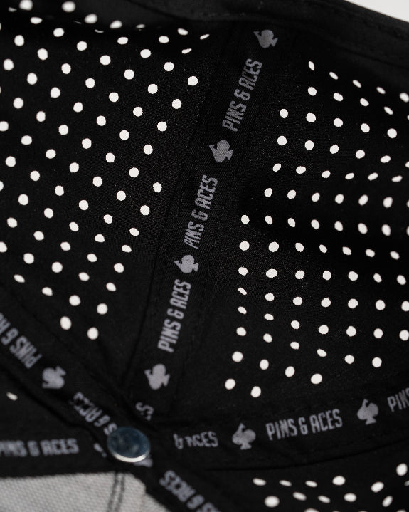 Thor’s Hammer Black perforated rope golf hat by Pins & Aces featuring a hammer-inspired design, adjustable snapback, breathable perforations, and built-in magnetic ball marker holder.