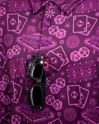 Men’s purple casino golf polo by Pins & Aces featuring an all-over pattern of playing cards, dice, poker chips, slot machines, and Las Vegas-inspired graphics.