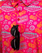 Men’s Big Ace Fuchsia golf polo by Pins & Aces featuring a bright pink casino print with playing cards, dice, poker chips, slot machines, and an athletic performance fit.