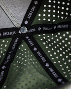 Olive green perforated rope golf hat by Pins & Aces featuring an embroidered Fairway Wave Spade logo, rope accent, adjustable snapback, and built-in magnetic golf ball marker holder.