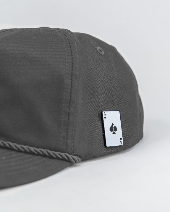 Heritage Charcoal rope golf hat by Pins & Aces featuring a low-profile 5-panel design, classic rope accent, adjustable snapback, and built-in magnetic golf ball marker holder.