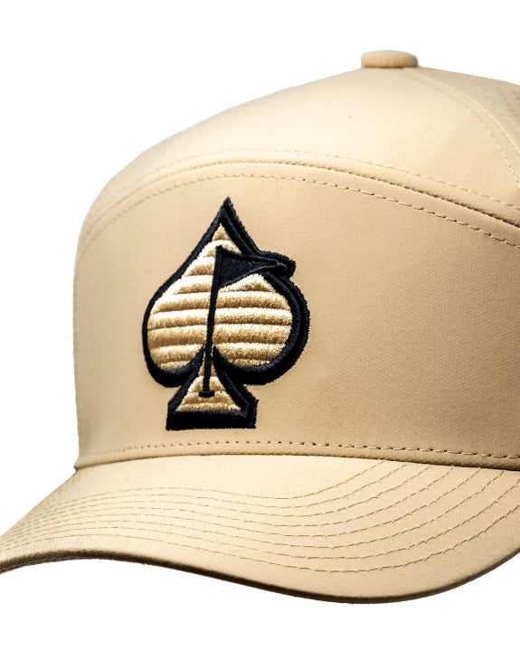 Tradesman Sand golf hat by Pins & Aces featuring a warm neutral sand colorway, adjustable snapback closure, and built-in magnetic golf ball marker holder.