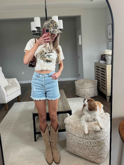 Brooke High Waisted Denim Shorts featuring a flattering high-rise waist, premium stretch denim, subtle distressed details, classic five-pocket styling, and a frayed hem for an effortless boutique summer look. Comes in a Light Wash
