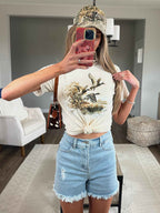Brooke High Waisted Denim Shorts featuring a flattering high-rise waist, premium stretch denim, subtle distressed details, classic five-pocket styling, and a frayed hem for an effortless boutique summer look. Comes in a Light Wash