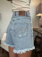 Brooke High Waisted Denim Shorts featuring a flattering high-rise waist, premium stretch denim, subtle distressed details, classic five-pocket styling, and a frayed hem for an effortless boutique summer look. Comes in a Light Wash