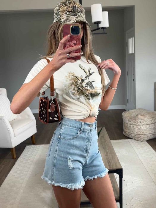 Brooke High Waisted Denim Shorts featuring a flattering high-rise waist, premium stretch denim, subtle distressed details, classic five-pocket styling, and a frayed hem for an effortless boutique summer look. Comes in a Light Wash