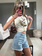 Brooke High Waisted Denim Shorts featuring a flattering high-rise waist, premium stretch denim, subtle distressed details, classic five-pocket styling, and a frayed hem for an effortless boutique summer look. Comes in a Light Wash