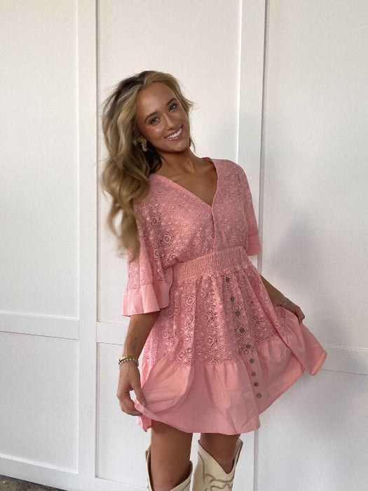 Hope Ruffle Hem Lace Mini Dress featuring delicate lace detailing, a flowy silhouette, feminine ruffle hem, and adjustable tie-back design, perfect for weddings, bridal showers, vacations, and spring or summer occasions. Color Light Blush
