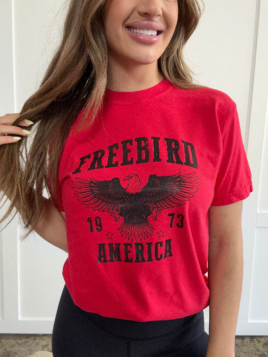 Women’s Freebird 1973 graphic tee featuring a bold Freebird America design, bald eagle graphic, black detailing, and vintage-inspired artwork on a Comfort Colors® cotton T-shirt.