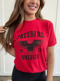 Women’s Freebird 1973 graphic tee featuring a bold Freebird America design, bald eagle graphic, black detailing, and vintage-inspired artwork on a Comfort Colors® cotton T-shirt.