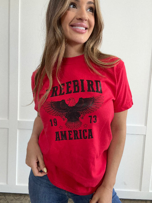 Women’s Freebird 1973 graphic tee featuring a bold Freebird America design, bald eagle graphic, black detailing, and vintage-inspired artwork on a Comfort Colors® cotton T-shirt in Red