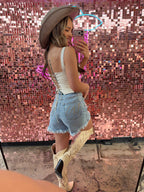 Brooke High Waisted Denim Shorts featuring a flattering high-rise waist, premium stretch denim, subtle distressed details, classic five-pocket styling, and a frayed hem for an effortless boutique summer look. Comes in a Light Wash