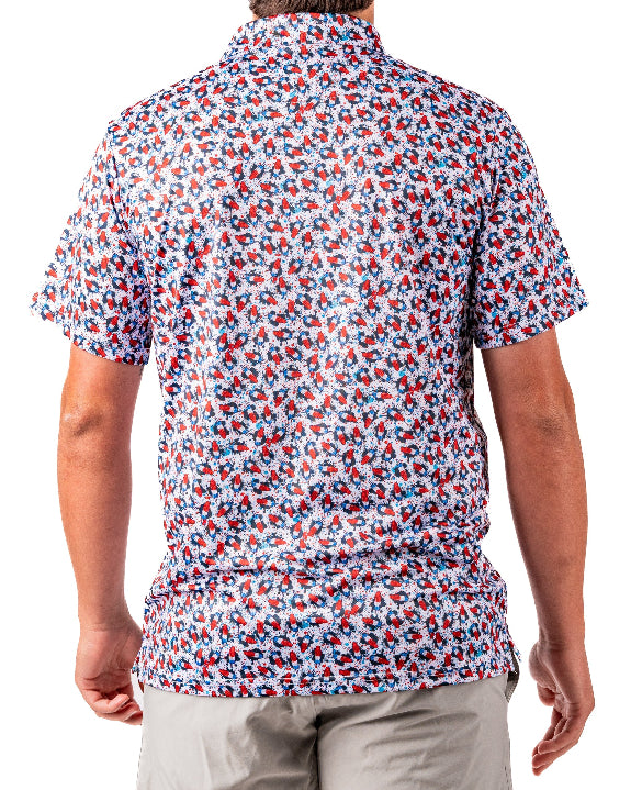 Men’s Bomb Pop Splatter golf polo by Pins & Aces featuring an all-over red, white, and blue splatter pattern with short sleeves and an athletic performance fit.