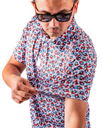 Men’s Bomb Pop Splatter golf polo by Pins & Aces featuring an all-over red, white, and blue splatter pattern with short sleeves and an athletic performance fit.