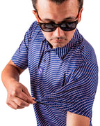 Men’s Wavy Stars & Stripes golf polo by Pins & Aces featuring a navy, red, and white wavy patriotic pattern with short sleeves and an athletic performance fit.