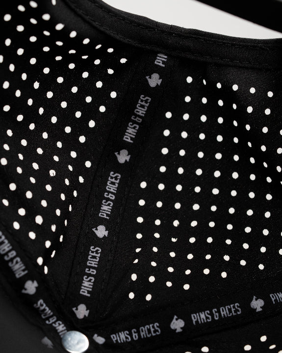 Ace/King Black perforated rope golf hat by Pins & Aces featuring a black poker-inspired design, braided rope accent, adjustable snapback, and built-in magnetic ball marker holder.