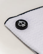 White Pins & Aces magnetic golf towel featuring durable waffle-knit fabric, a strong built-in magnet, center slit, and carabiner for attaching to a golf bag.