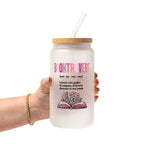 Clear glass cup with bamboo lid and straw featuring pink Booktrovert lettering, a definition about preferring fictional characters to real people, and an open book filled with pink and purple flowers.