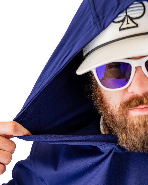 Men’s navy performance golf hoodie by Pins & Aces featuring a lightweight long-sleeve design, lay-flat hood, embroidered spade chest logo, and relaxed athletic fit.