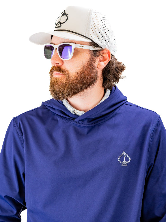 Men’s navy performance golf hoodie by Pins & Aces featuring a lightweight long-sleeve design, lay-flat hood, embroidered spade chest logo, and relaxed athletic fit.