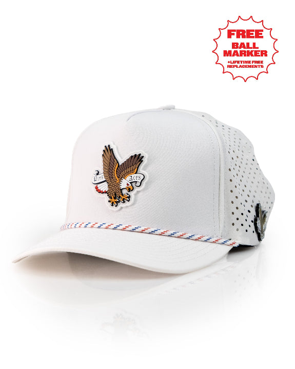 Freedom Eagle White perforated rope golf hat by Pins & Aces featuring a patriotic eagle design, adjustable snapback, magnetic ball marker holder, and matching golf ball marker.
