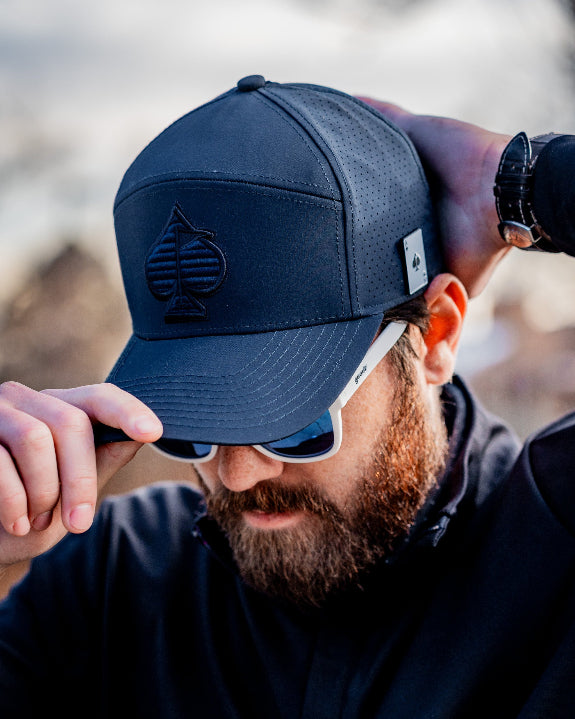 Tradesman Navy golf hat by Pins & Aces featuring a tonal embroidered spade logo, structured 6-panel design, perforated side panels, curved bill, and adjustable snapback.