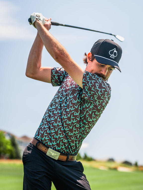 Men’s Cocoa Verde golf polo by Pins & Aces featuring a cocoa brown background with an all-over teal geometric print, short sleeves, and athletic performance fit.