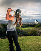 Pins & Aces Women’s Coral Cascades performance golf polo featuring a women’s athletic fit with fast-wicking fabric, SPF 45+ protection and a built-in sunglasses holder.