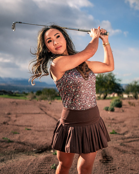 Women’s Desert Sage performance golf polo by Pins & Aces featuring a lightweight breathable design, short sleeves, athletic fit, and moisture-wicking golf fabric.