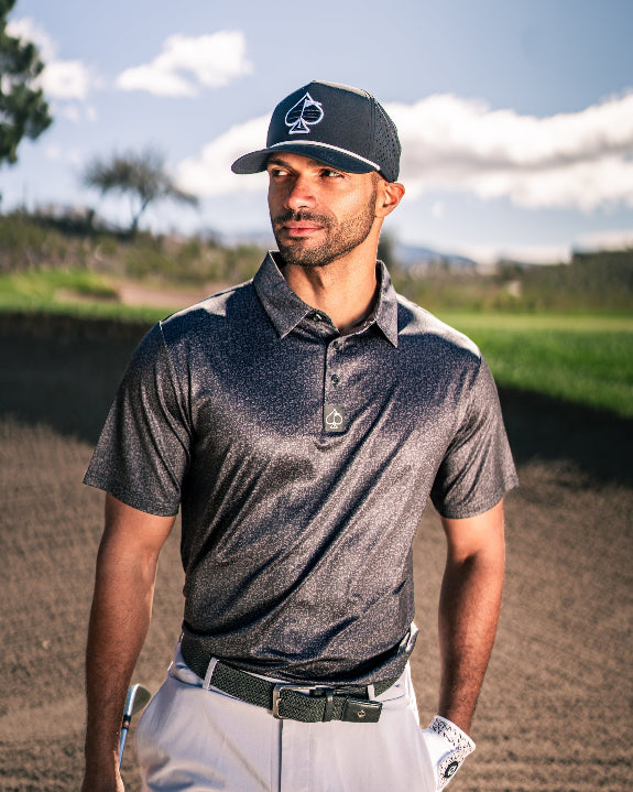 Men’s Man’s Best Friend Dark golf polo by Pins & Aces featuring a subtle dog-inspired pattern on a dark charcoal performance polo with short sleeves and athletic fit.