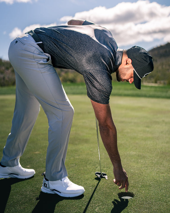 Men’s Man’s Best Friend Dark golf polo by Pins & Aces featuring a subtle dog-inspired pattern on a dark charcoal performance polo with short sleeves and athletic fit.