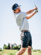 Men’s Man’s Best Friend Light golf polo by Pins & Aces featuring a subtle dog-inspired micro print in light blue and white with short sleeves and an athletic performance fit.