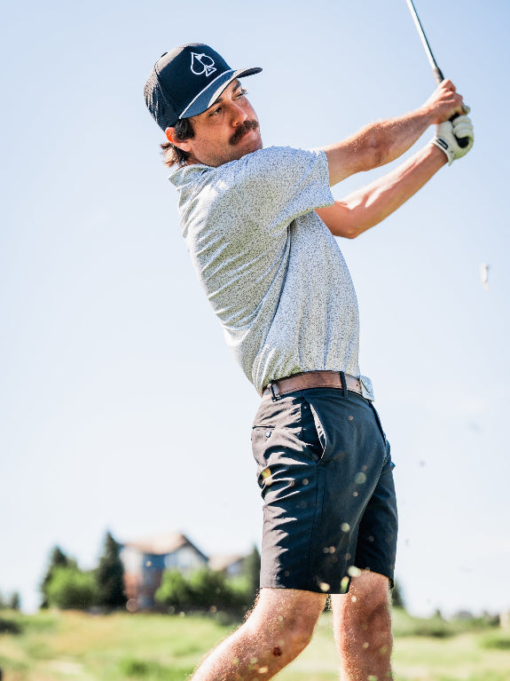 Men’s Man’s Best Friend Light golf polo by Pins & Aces featuring a subtle dog-inspired micro print in light blue and white with short sleeves and an athletic performance fit.