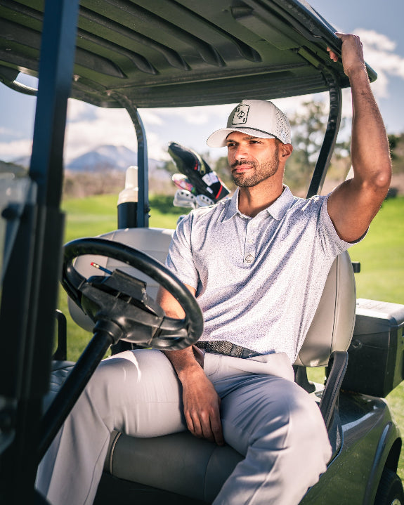 Men’s Man’s Best Friend Light golf polo by Pins & Aces featuring a subtle dog-inspired micro print in light blue and white with short sleeves and an athletic performance fit.