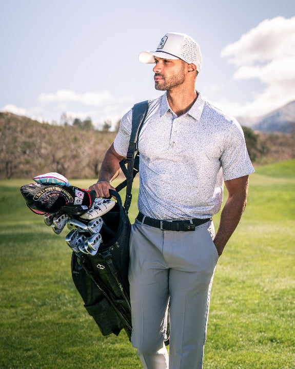 Men’s Man’s Best Friend Light golf polo by Pins & Aces featuring a subtle dog-inspired micro print in light blue and white with short sleeves and an athletic performance fit.