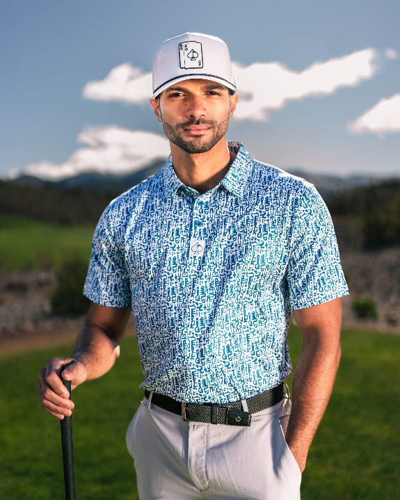 Men’s Maze Craze golf polo by Pins & Aces featuring an all-over blue maze-inspired geometric pattern with short sleeves and an athletic performance fit.