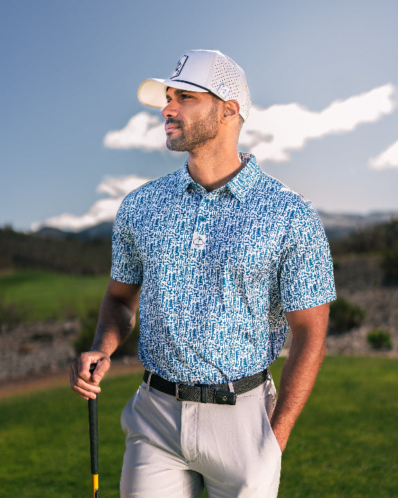 Men’s Maze Craze golf polo by Pins & Aces featuring an all-over blue maze-inspired geometric pattern with short sleeves and an athletic performance fit.