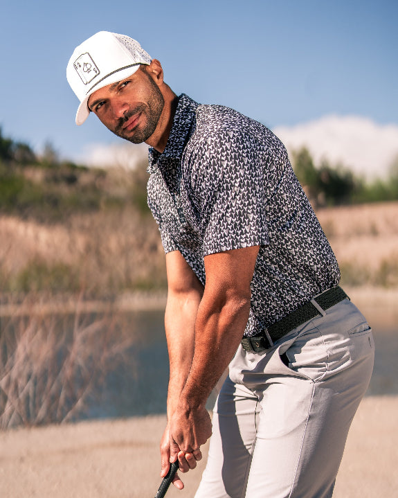 Men’s Shark Tooth golf polo by Pins & Aces featuring an all-over black, charcoal, gray, and white shark tooth-inspired micro print with short sleeves and an athletic performance fit.