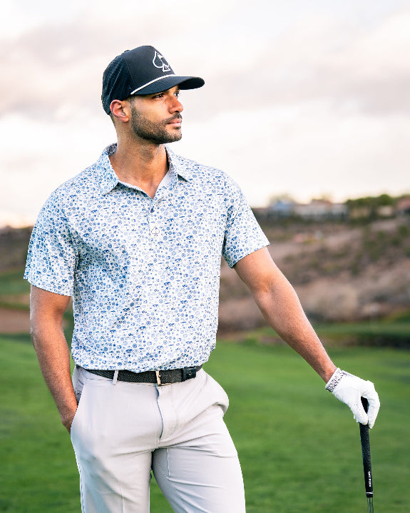 Pins & Aces Signal Boost men’s performance golf polo featuring an athletic fit with breathable fast-wicking fabric, SPF 45+ protection, and built-in sunglasses holder.
