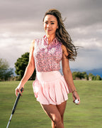 Women’s Soft Spoken golf polo by Pins & Aces featuring a sleeveless collared design with an all-over coral, pink, gray, and black micro floral print and athletic performance fit.