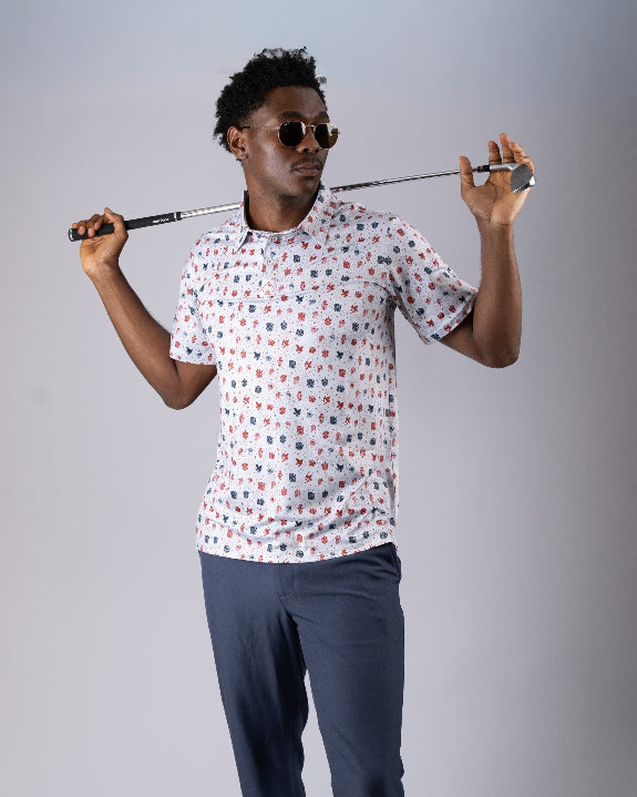 Pins & Aces American Traditional men’s golf polo featuring a bold patriotic Americana and classic tattoo flash-inspired design with an athletic performance fit.
