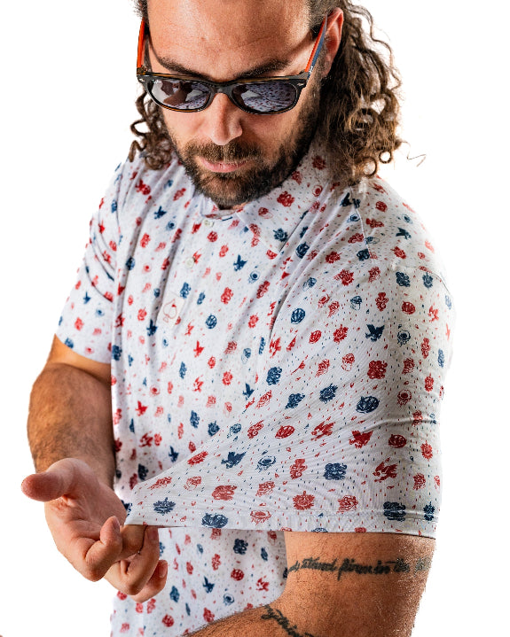 Pins & Aces American Traditional men’s golf polo featuring a bold patriotic Americana and classic tattoo flash-inspired design with an athletic performance fit.