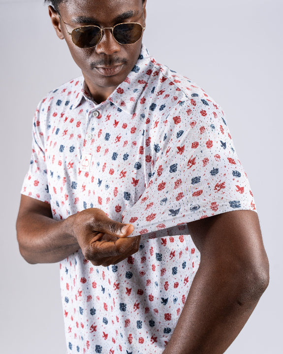 Pins & Aces American Traditional men’s golf polo featuring a bold patriotic Americana and classic tattoo flash-inspired design with an athletic performance fit.