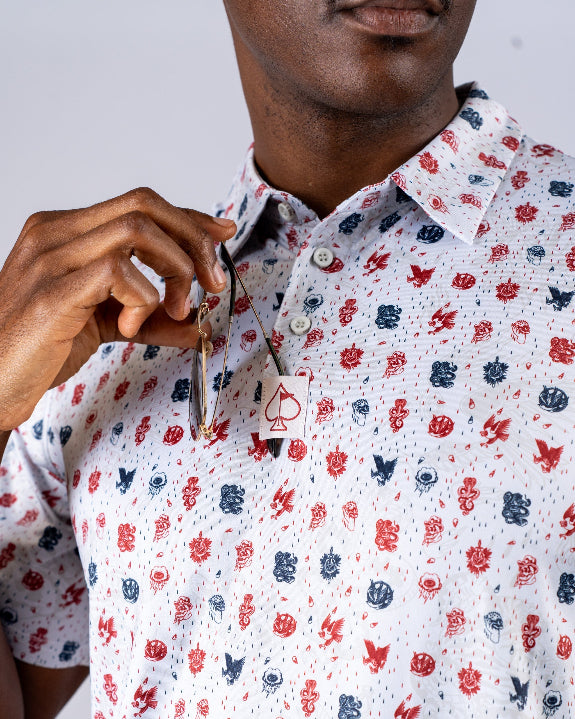 Pins & Aces American Traditional men’s golf polo featuring a bold patriotic Americana and classic tattoo flash-inspired design with an athletic performance fit.
