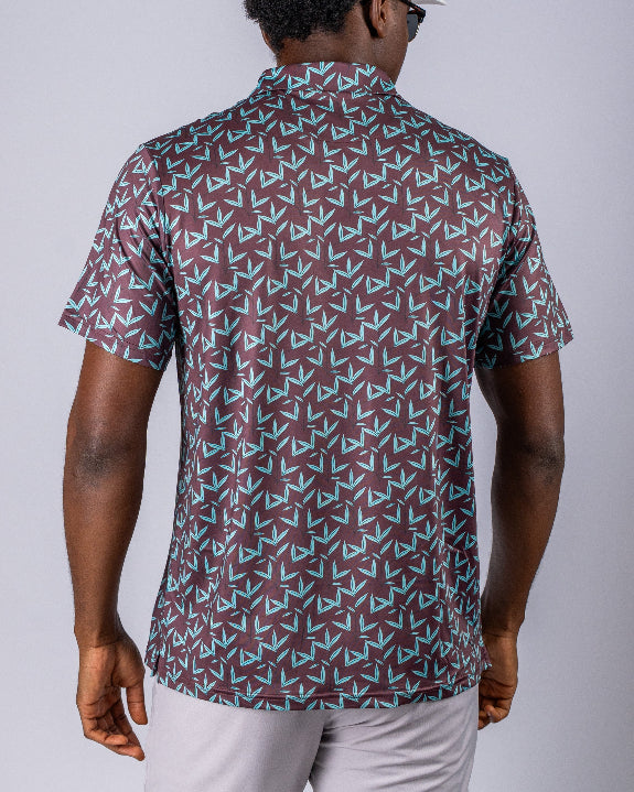 Men’s Cocoa Verde golf polo by Pins & Aces featuring a cocoa brown background with an all-over teal geometric print, short sleeves, and athletic performance fit.