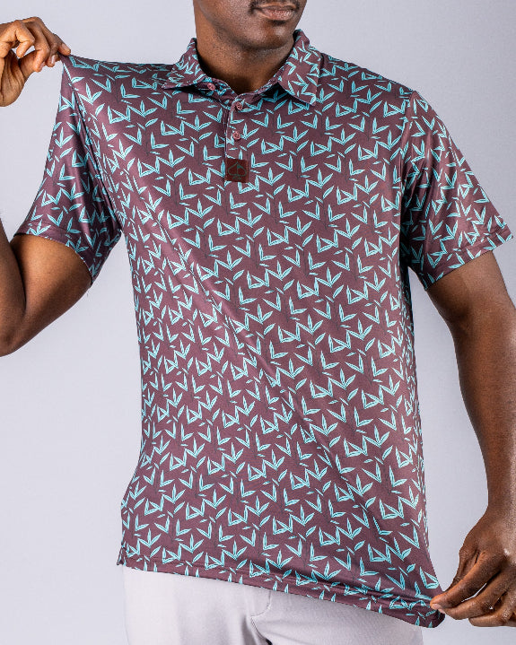 Men’s Cocoa Verde golf polo by Pins & Aces featuring a cocoa brown background with an all-over teal geometric print, short sleeves, and athletic performance fit.