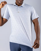 Men’s Man’s Best Friend Light golf polo by Pins & Aces featuring a subtle dog-inspired micro print in light blue and white with short sleeves and an athletic performance fit.