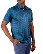 Men’s Manta Ray golf polo by Pins & Aces featuring a deep ocean blue all-over aquatic-inspired pattern, short sleeves, collared neckline, and athletic performance fit.