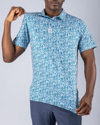 Men’s Maze Craze golf polo by Pins & Aces featuring an all-over blue maze-inspired geometric pattern with short sleeves and an athletic performance fit.